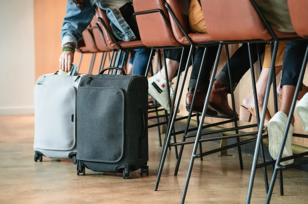 Suitcases lined up at a bar